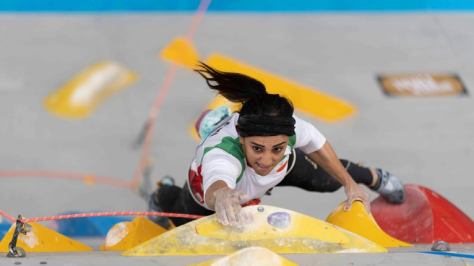 Iranian greeted as hero after competing without hijab